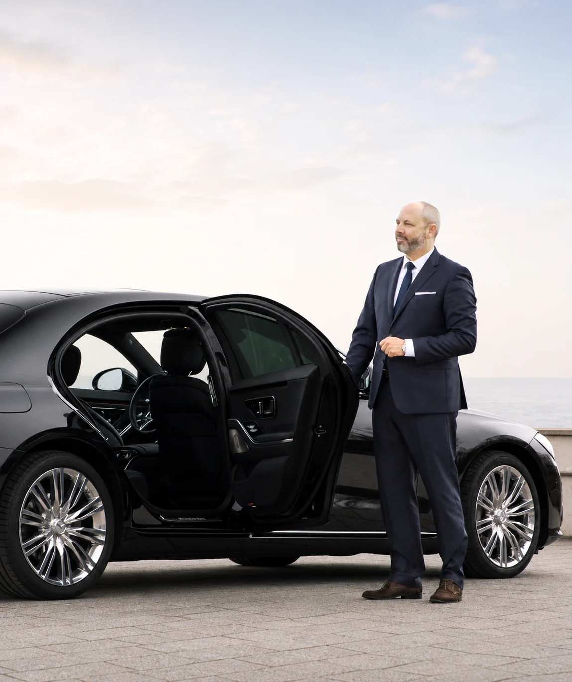 Chauffeur opening the door of the Mercedes-Benz S-Class