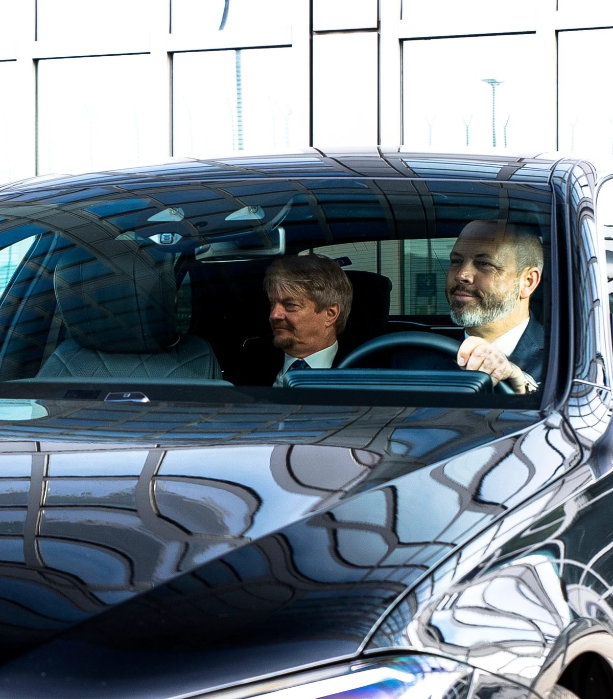 Passenger and chauffeur in the rear of the Mercedes-Benz S-Class during a business journey