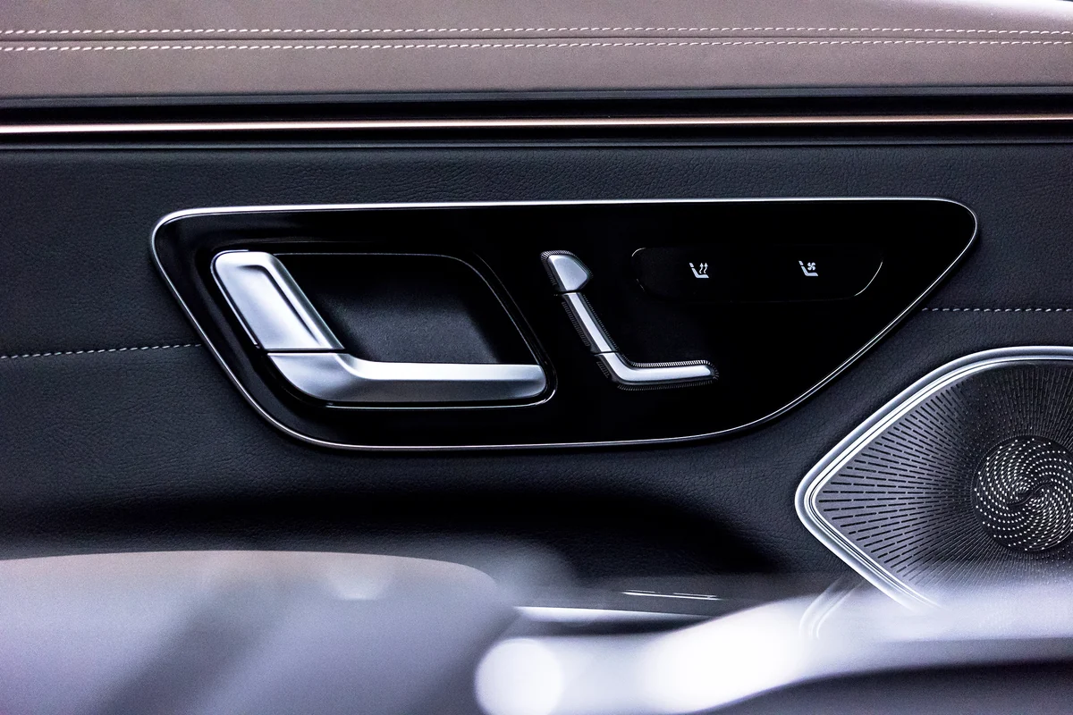 Door handle and controls in the rear of a dark sedan