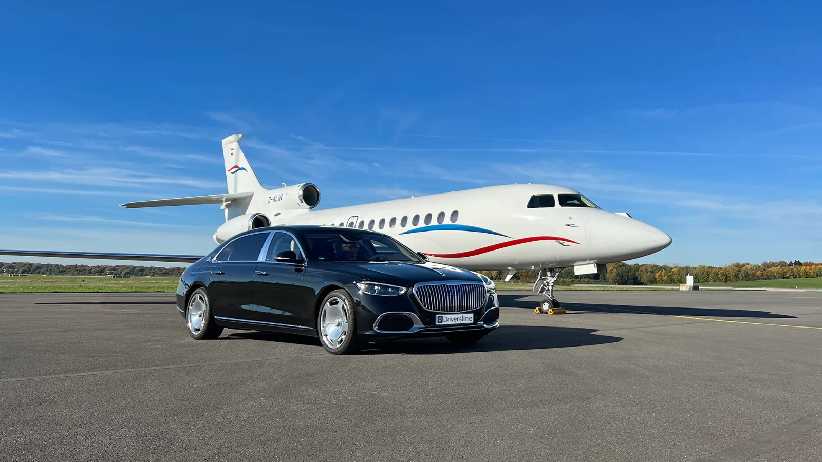Black Driversline Mercedes-Maybach in front of a private jet