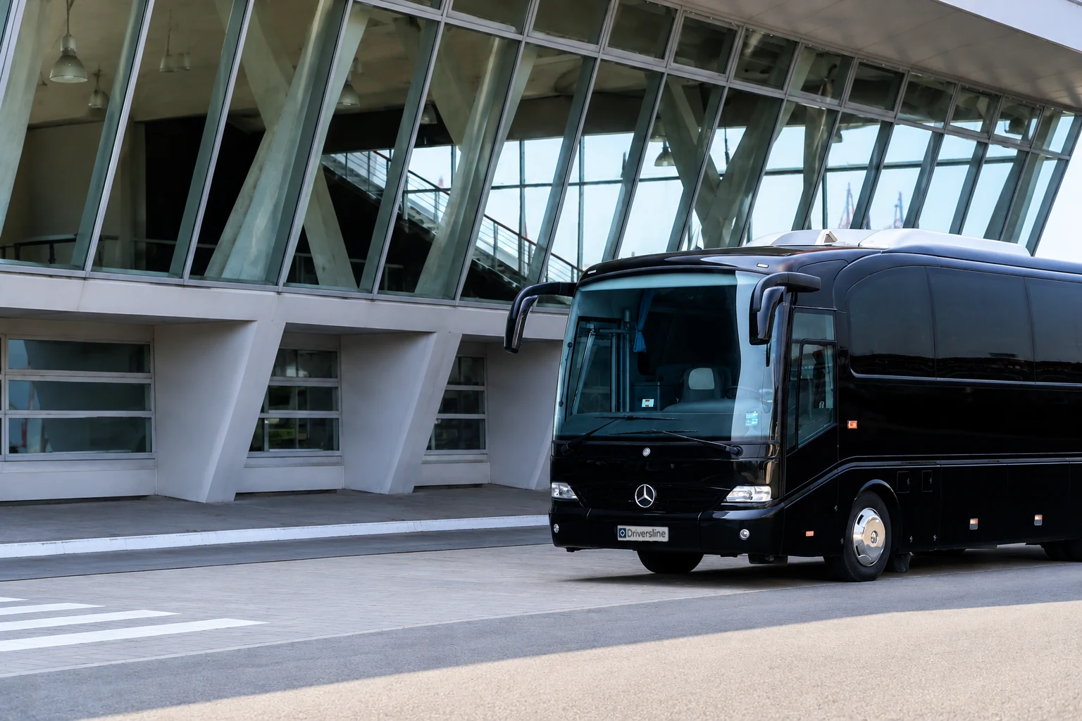 Reisebus von Driversline vor einer Glasfassade