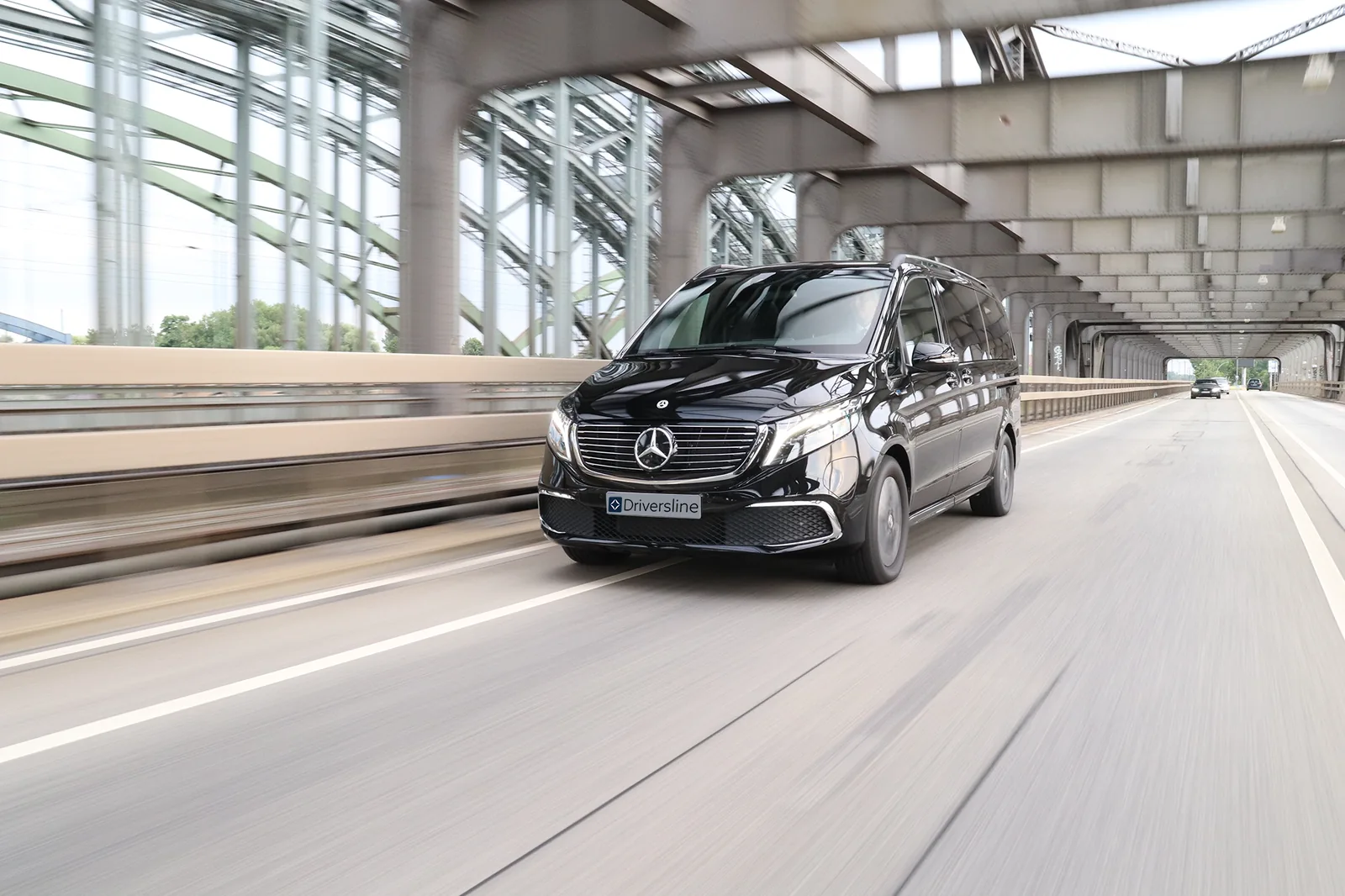 Mercedes-Benz VIP van crossing a bridge, number plate with the Driversline lettering