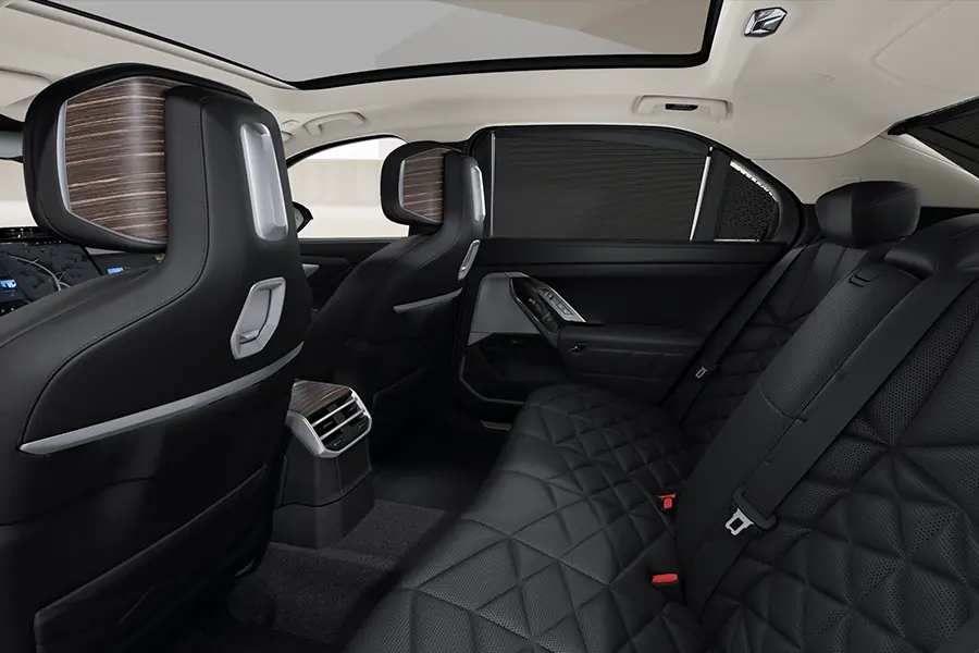 Rear of the BMW i7 with black diamond-quilted seats and the sun blinds extended