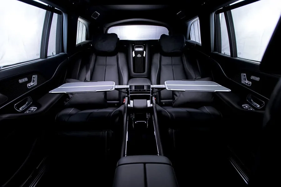 Rear lounge of the Mercedes-Maybach GLS with two individual seats and the tables folded out