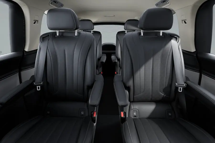 Rear of the Mercedes-Benz VLE with two black individual seats and a walkway to the second row