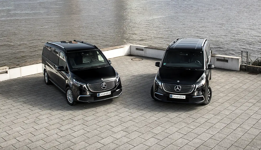 Two black Driversline Mercedes-Benz vans side by side on a waterfront promenade