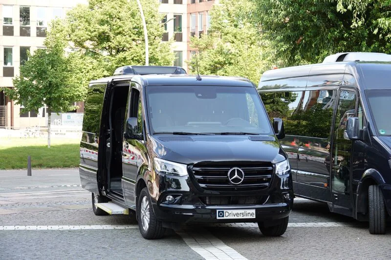 The open side door of a Mercedes-Benz VIP Sprinter with the step extended