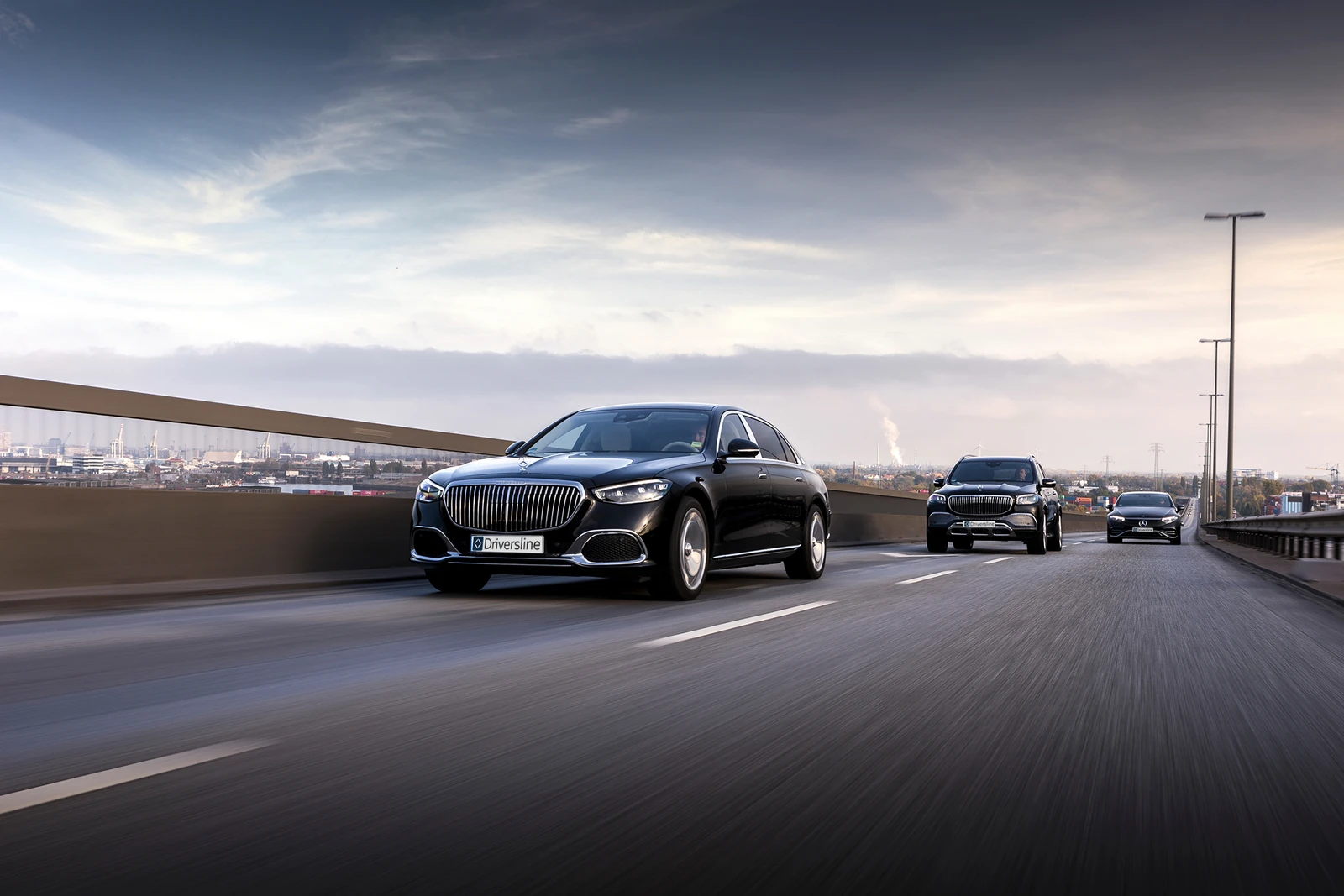 Three Mercedes-Benz sedans in convoy on the motorway