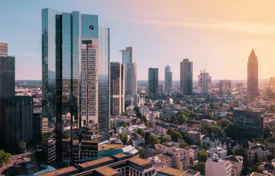 Frankfurt am Main skyline at sunset, with the river Main in front
